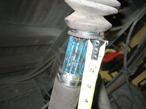1996 Ford Bronco - Measuring the diameter of a CV axle shaft, likely for replacement or inspection.