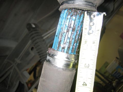 1996 Ford Bronco - A tape measure is used to show the size of a driveshaft spline covered in grease.