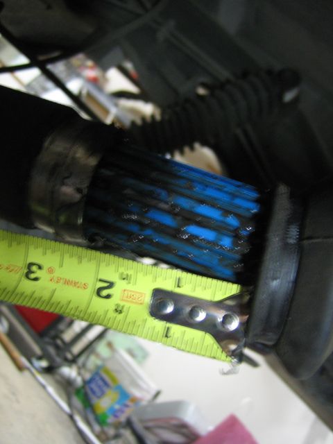 1996 Ford Bronco - A close-up view of a driveshaft's splined end, showing blue grease and being measured with a tape measure.