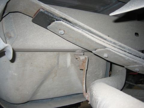 1996 Ford Bronco - Underside view of a vehicle's rear suspension components, including a leaf spring and fuel tank.