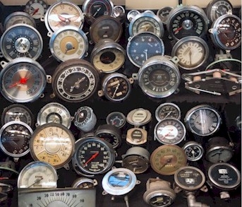 1996 Ford Probe - A variety of vintage automotive gauges are displayed, some the Buick brand, suggesting a collection of classic car parts.