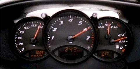 1996 Ford Probe - Dashboard gauges display speed, RPM, fuel level, and temperature. Digital readout shows 243 km.