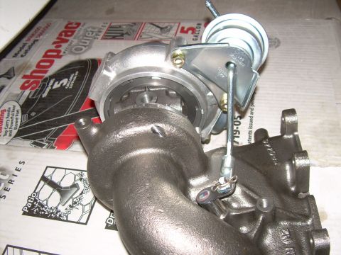 1996 Ford Probe - A turbocharger assembly is shown in detail, placed on top of a cardboard box.