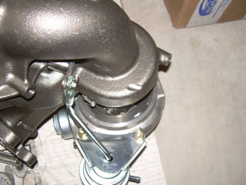 1996 Ford Probe - Close-up view of a turbocharger, showing the wastegate actuator and a visible part number.