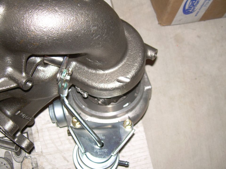 Turbocharger with wastegate actuator and part number visible