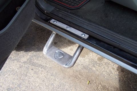1990 Ford Bronco - Running board step with textured grip and emblem, likely from an SUV or truck.
