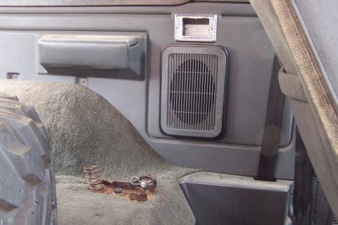 1990 Ford Bronco - Close-up of the interior showing a speaker grille and a spare tire.
