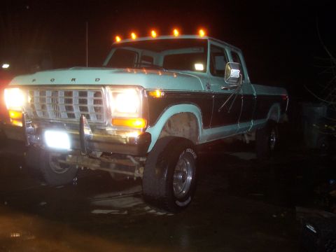 1994 Ford F-150 - A light blue and dark brown Ford F-Series truck is shown at a three-quarter front angle at night.