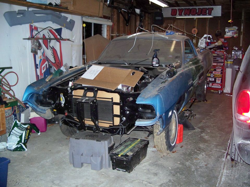 Blue 1971 Ford Ranchero front view in garage, hood open, undergoing repairs