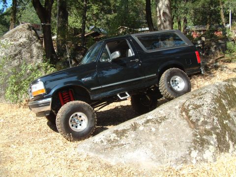 1996 Ford Bronco - This 1996 Ford Bronco is navigating a rocky obstacle on an outdoor trail.