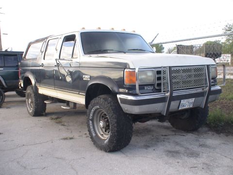 1993 Ford C-350 (Centurion Conversions) - This 1993 Ford C-350 Centurion Conversions features a two-tone paint scheme and an aftermarket grille guard.