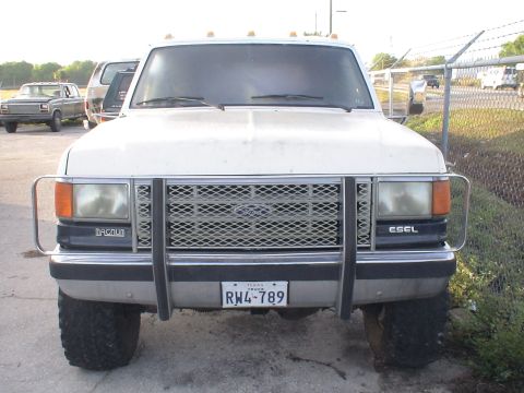 1993 Ford C-350 (Centurion Conversions) - Front view of a Ford F-Series truck, possibly a 1992 model, with a grille guard and aftermarket bumper.