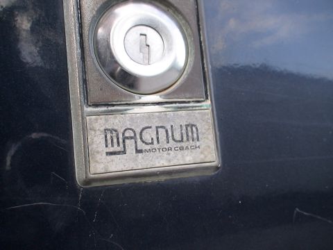 1993 Ford C-350 (Centurion Conversions) - The emblem reads "MAGNUM MOTOR COACH" and is located near a keyhole.