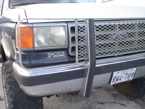 1993 Ford C-350 (Centurion Conversions) - This Ford pickup truck features a prominent brush guard and a 'MAGNUM' emblem on its front grille.