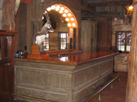 1996 Ford Bronco - A taxidermied deer head is mounted above a polished wooden bar in a dimly lit, rustic establishment.