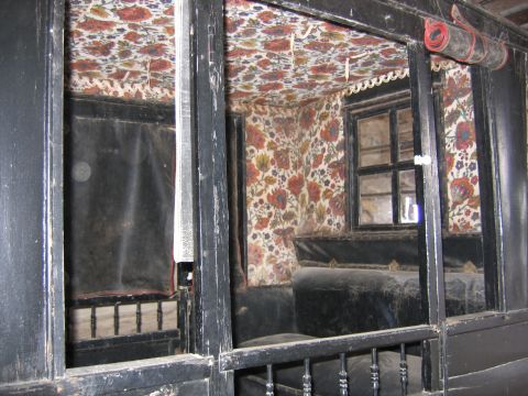 1996 Ford Bronco - Interior view of a vintage horse-drawn carriage, floral patterned walls and ceiling.