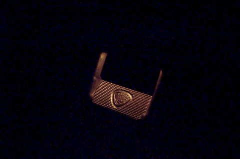 1990 Ford Bronco - A car emblem is shown against a dark background.