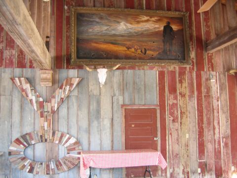 1996 Ford Bronco - A rustic room features a large painting, a longhorn skull, and decorative 'YO' letters on a wooden wall.