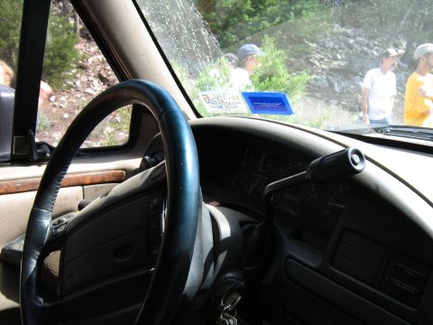 1996 Ford Bronco - The interior of a 1992 Ford Bronco, with a view of the dashboard and steering wheel, and people visible outside.