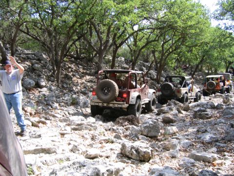 1996 Ford Bronco - Off-roading adventure with multiple Jeeps on a challenging rocky trail.