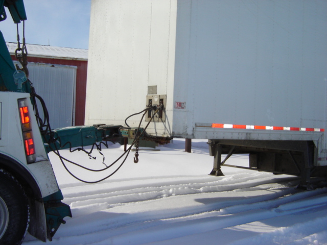 Tow truck rear with trailer hitch in snowy conditions