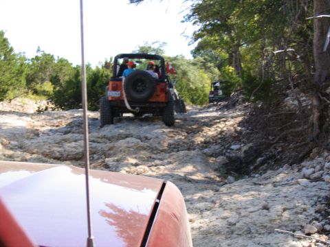 1996 Ford Bronco - Jeeps navigate a challenging rocky trail during an off-road excursion.