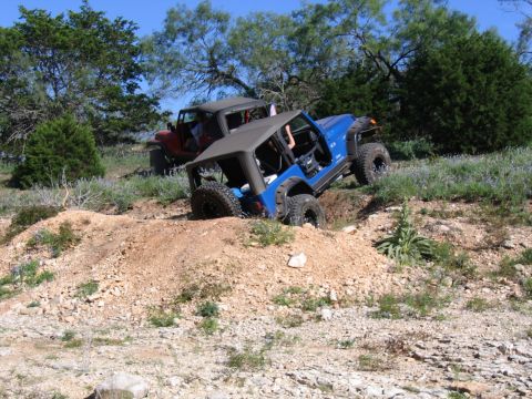 1996 Ford Bronco - Two Jeeps navigating challenging terrain off-road.