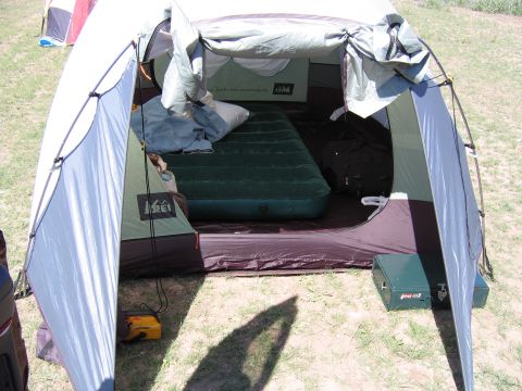 1996 Ford Bronco - The interior of a camping tent is set up with an air mattress and sleeping gear, ready for use.