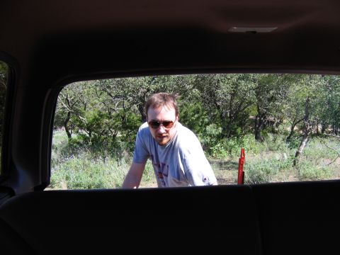 1996 Ford Bronco - View from inside a vehicle shows a man looking out at a natural landscape.