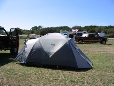 1996 Ford Bronco - A campsite scene with multiple vehicles and tents under a clear blue sky.
