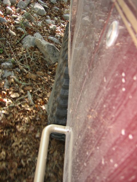 1996 Ford Bronco - Driving off-road on a trail covered in rocks and fallen leaves.