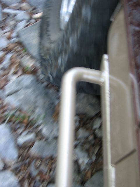 1996 Ford Bronco - Tire and rocky ground seen from a low angle.