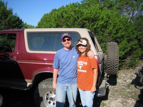 1996 Ford Bronco - A couple poses in front of a classic Ford Bronco SUV during an outdoor excursion.