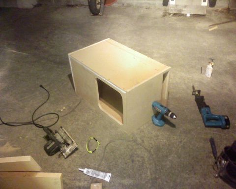 1995 Ford Bronco - Tools and a partially assembled wooden enclosure sit on a concrete floor.