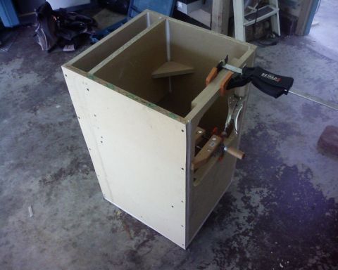 1995 Ford Bronco - A wooden box is being assembled with clamps on a concrete floor.