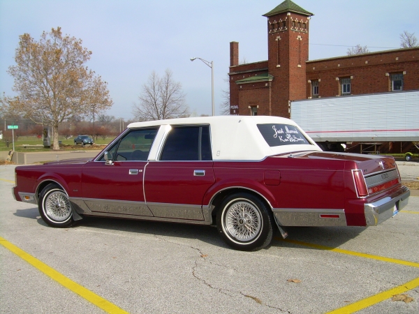 Red 1989 Lincoln Town Car with white vinyl roof, rear 3/4 view. "Just Married" written on rear window
