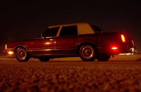 1989 Lincoln Town Car - Maroon 1989 Lincoln Town Car with a tan vinyl roof parked at night.