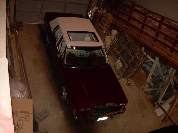 1989 Lincoln Town Car, maroon sedan with white vinyl top, parked in garage