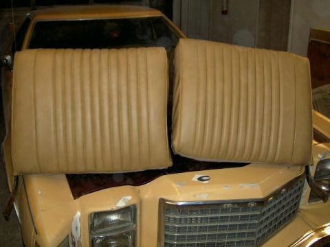 1967 Ford Ranchero - Car seats placed on the hood of a vehicle. The vehicle's grille and headlights are visible.