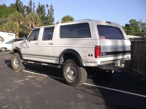 1993 Ford C-350 (Centurion Conversions) - This extended cab pickup truck with a camper shell appears to be from the early 1990s, not a 1993 model.