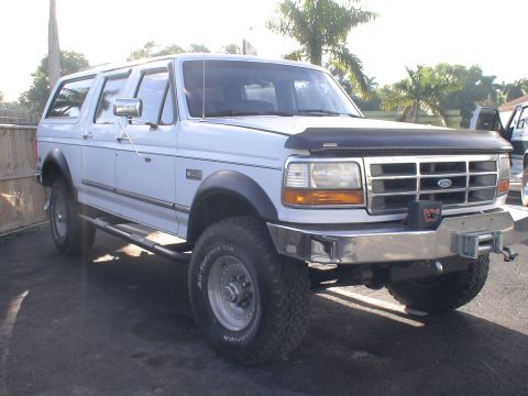 1993 Ford C-350 (Centurion Conversions) - White SUV with aftermarket bumper and winch, 3/4 front view.