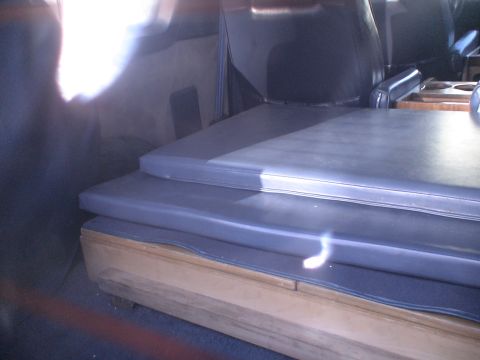 1993 Ford C-350 (Centurion Conversions) - Stacked cushions are visible inside the van's interior.