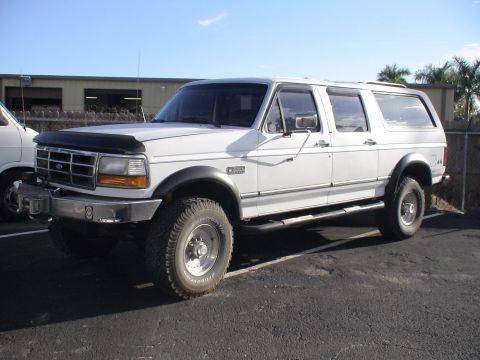 1993 Ford C-350 (Centurion Conversions) - White Ford SUV, likely a Centurion conversion, parked outdoors.