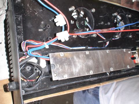 1993 Ford C-350 (Centurion Conversions) - The internal components of an electronic device are visible, including wiring, cooling fans, and a metal heat sink.