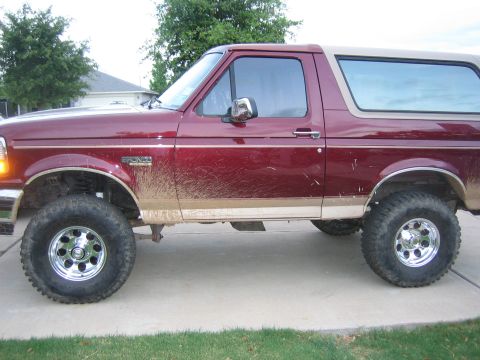 1996 Ford Bronco - This 1996 Ford Bronco shows off its off-road capabilities with a significant amount of mud splattered on its side.