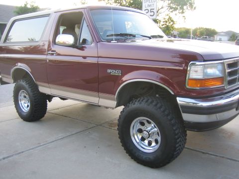 1996 Ford Bronco - Maroon 1996 Ford Bronco with tan two-tone trim and chrome wheels.