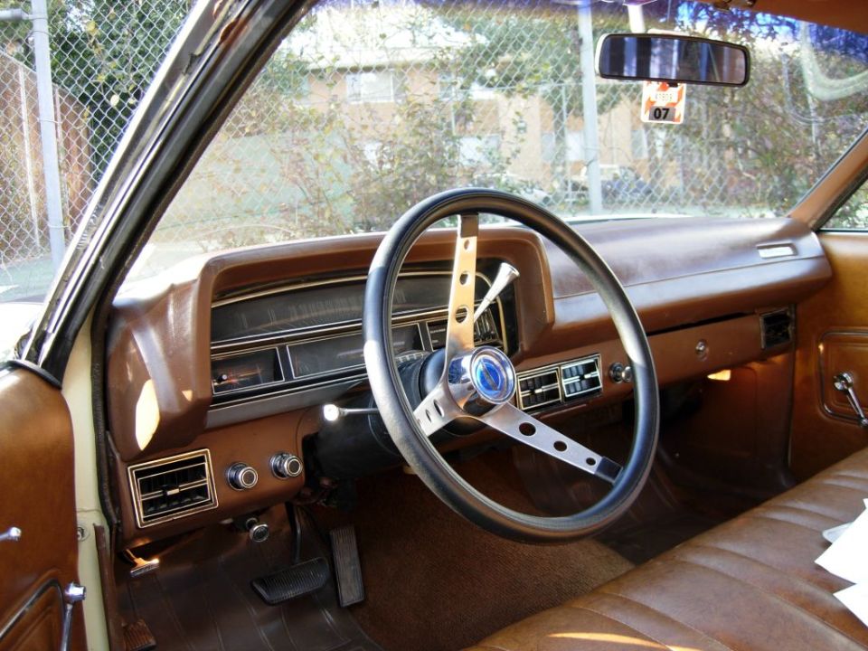 Brown interior of a 1970 Ford Ranchero with a three-spoke steering wheel and dashboard