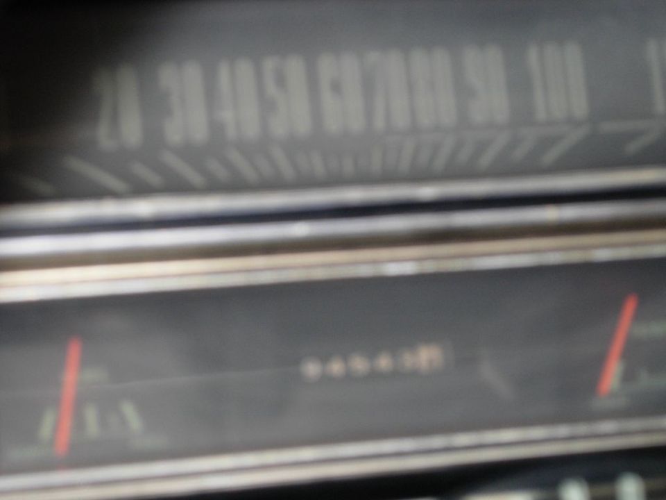 Car dashboard with speedometer and odometer visible. Speedometer reads 20-100 mph