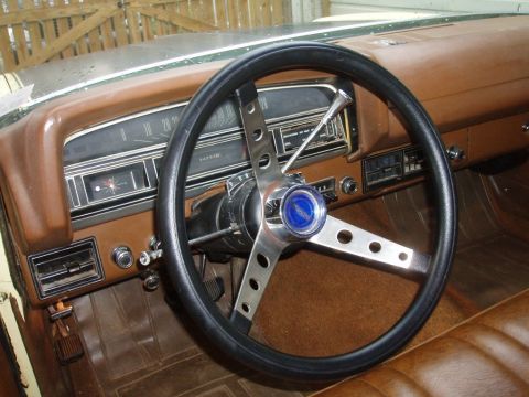 1970 Ford Ranchero - The dashboard and steering wheel of a vintage vehicle are shown in this interior photograph.