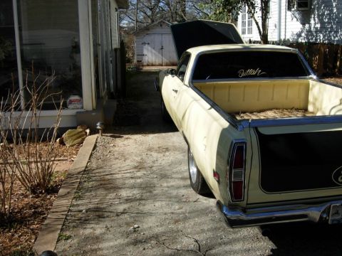 1970 Ford Ranchero - Cream-colored 1970 Ford Ranchero pickup truck with its hood open, seen from the rear.